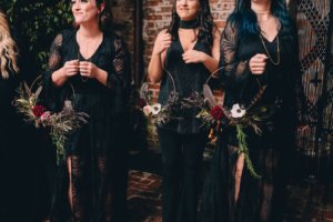 bridesmaids in black with bouquets