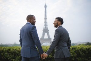 male couple in front of the Eiffel Tower, Paris