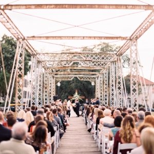 wedding on bridge with cross at altar over bayou st john in new orleans